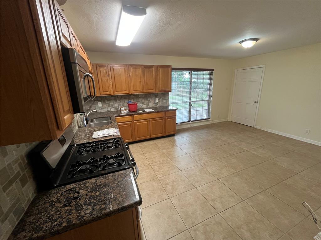 a kitchen with a stove a sink and a refrigerator