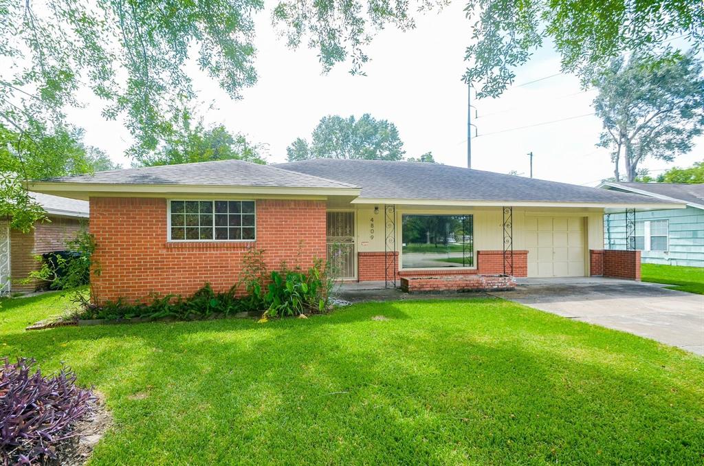 a view of a house with a yard and sitting area