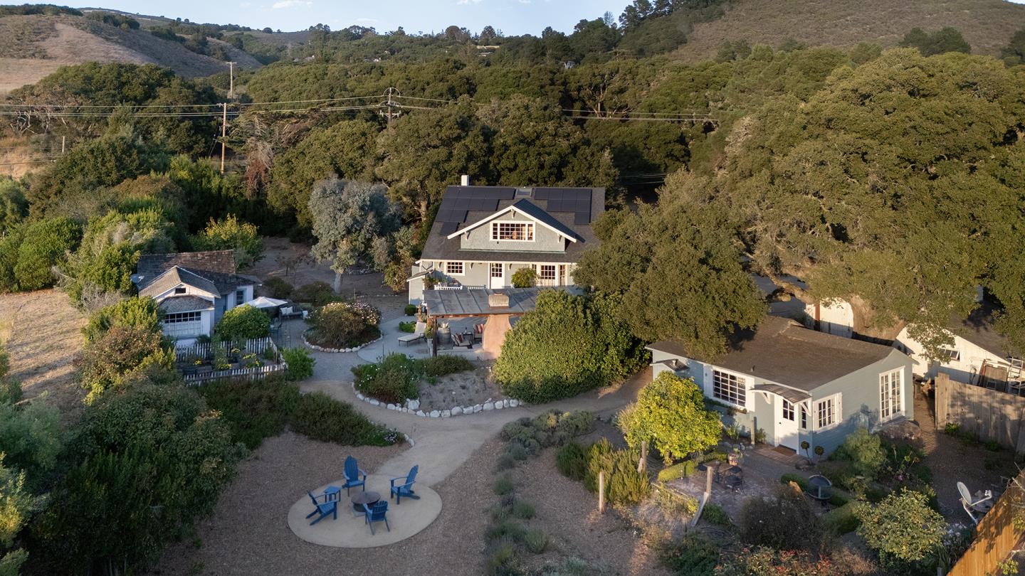 an aerial view of a house with garden space and street view