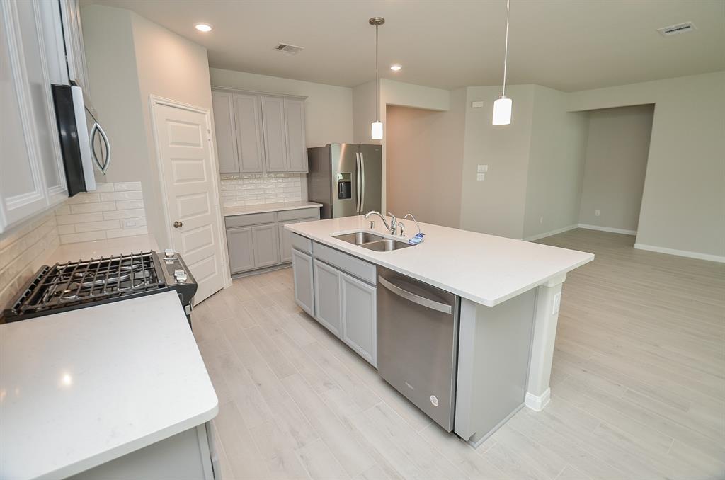 a kitchen with a sink stove and refrigerator