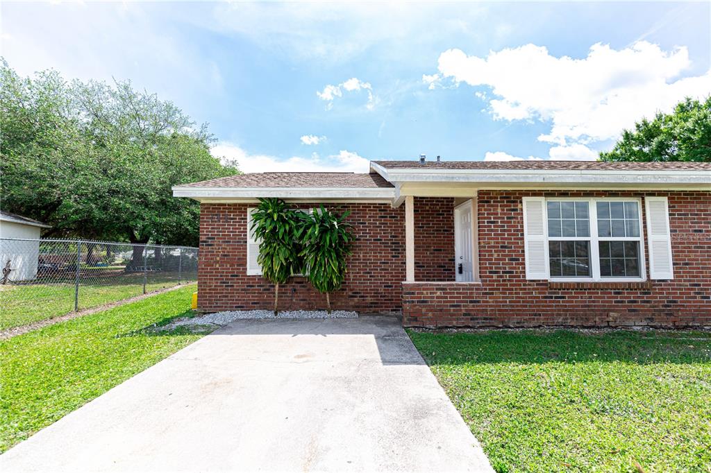 a front view of a house with a yard and porch