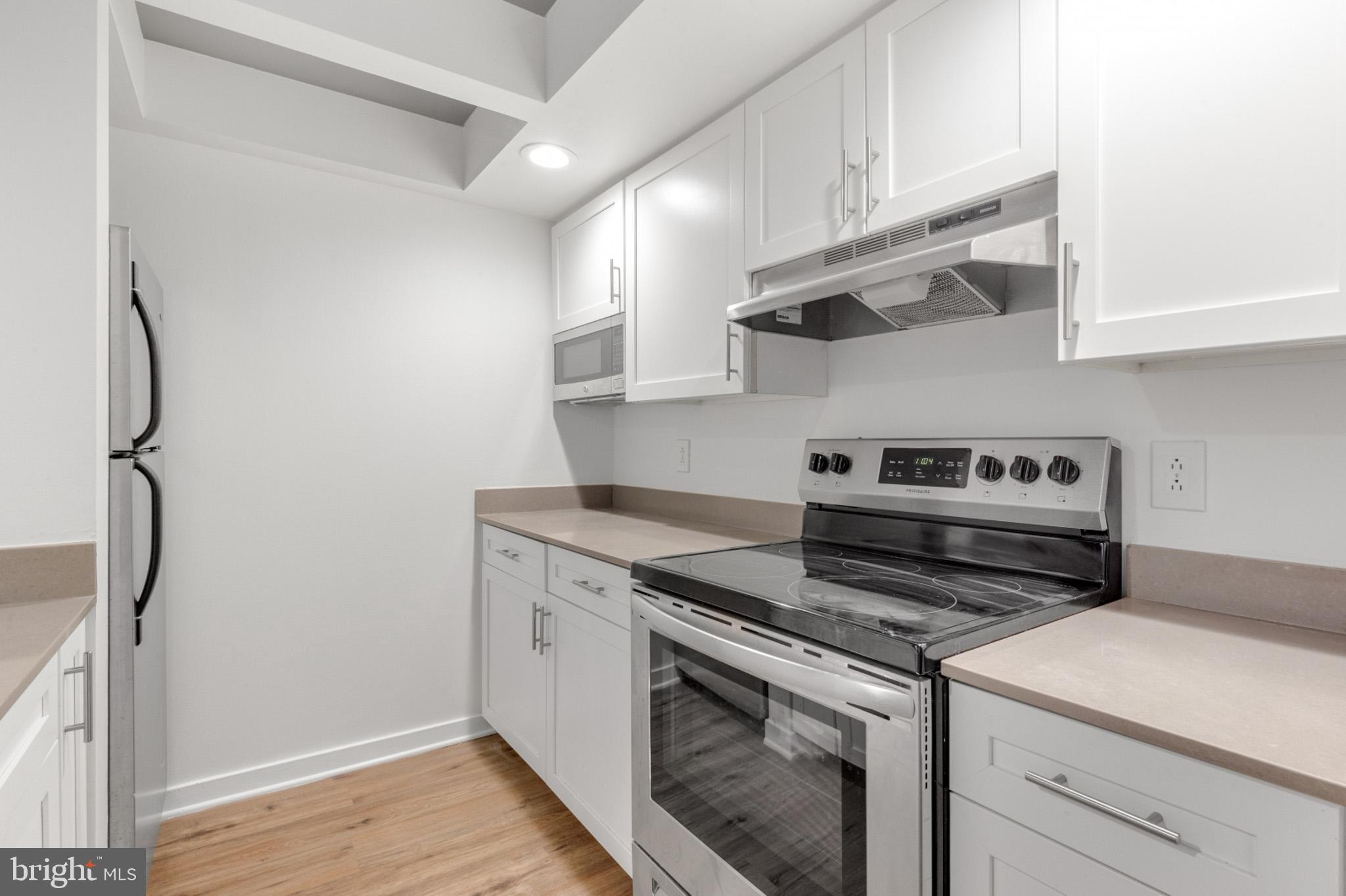 a kitchen with stainless steel appliances granite countertop a stove and a refrigerator