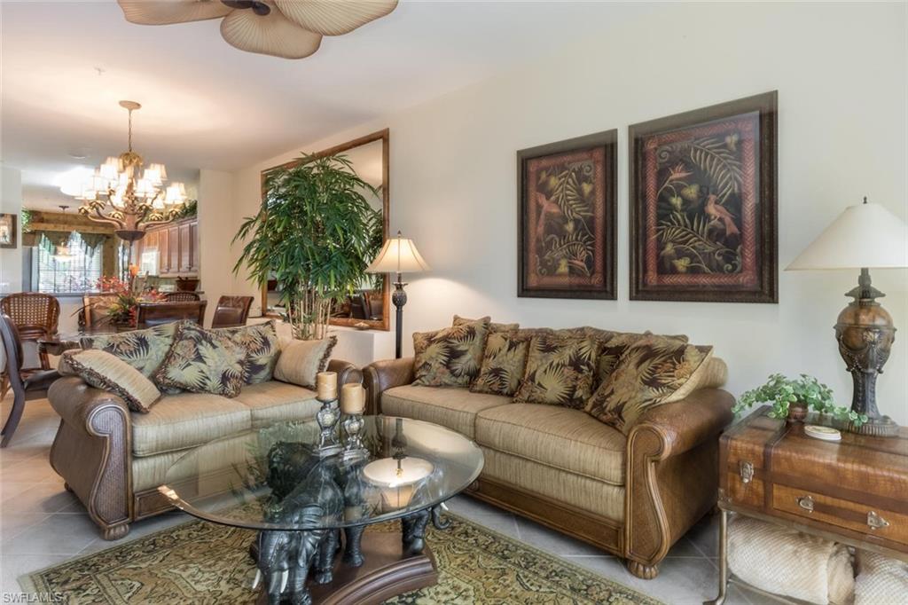 a living room with furniture and a large mirror