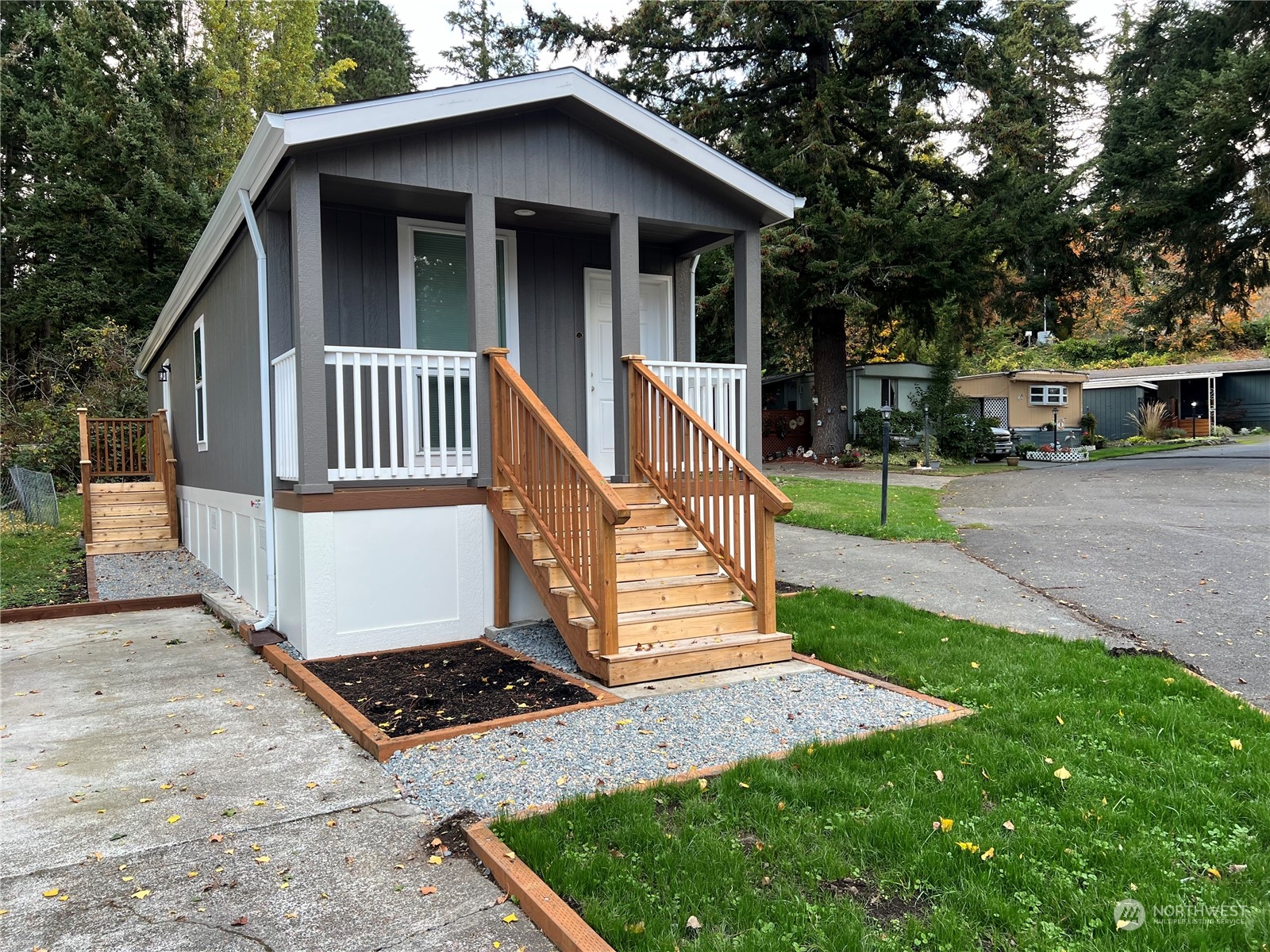 a view of a house with wooden fence and a yard