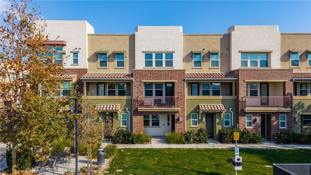 a front view of a residential apartment building with a yard