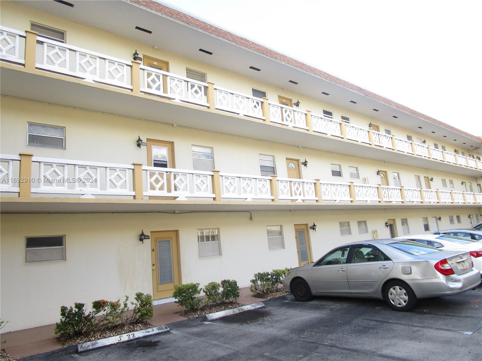 a view of a cars park in front of a building