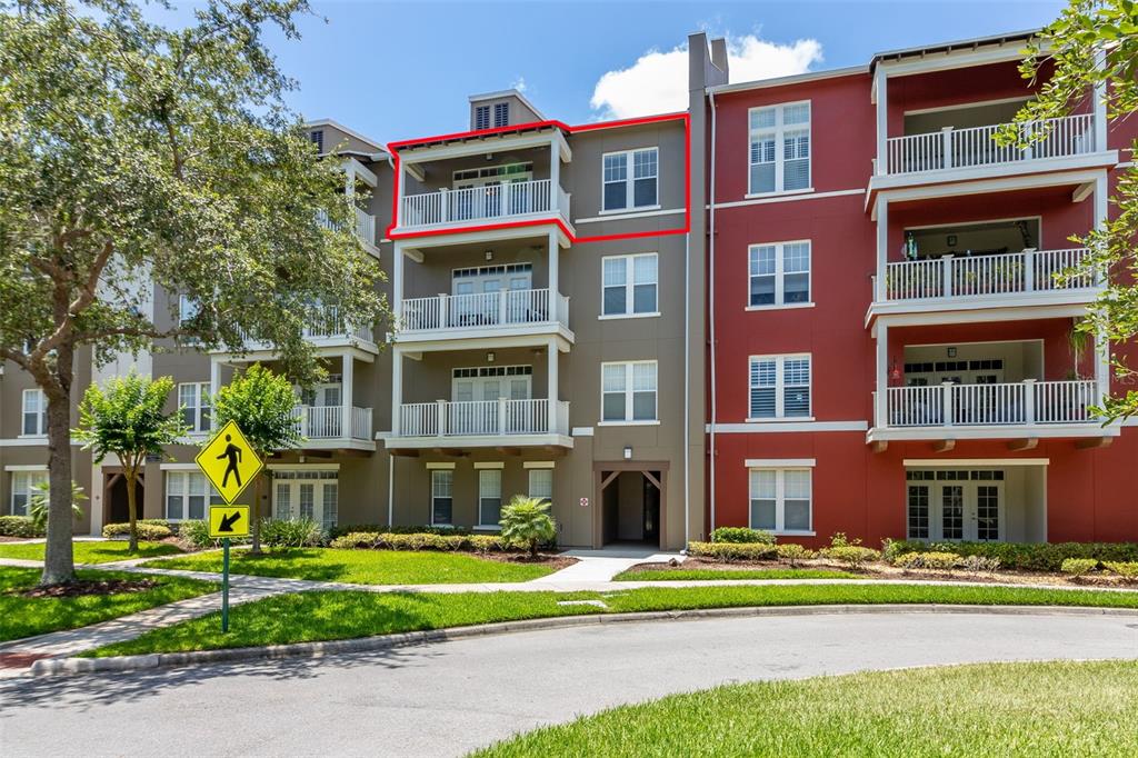 a front view of a residential apartment building with a yard