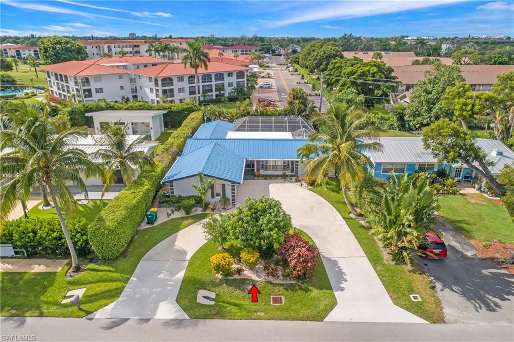 an aerial view of a house with a garden and lake view