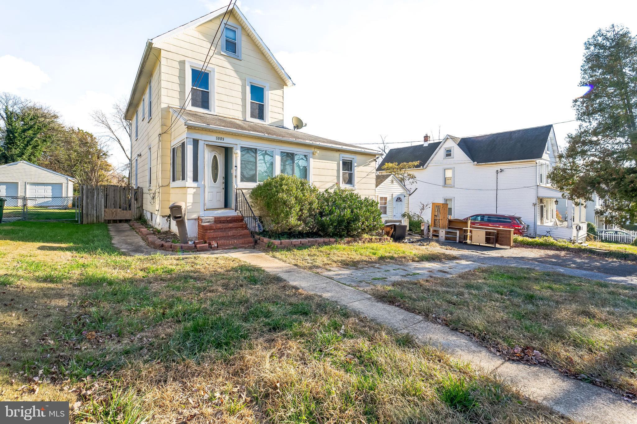 a front view of a house with yard and outdoor seating