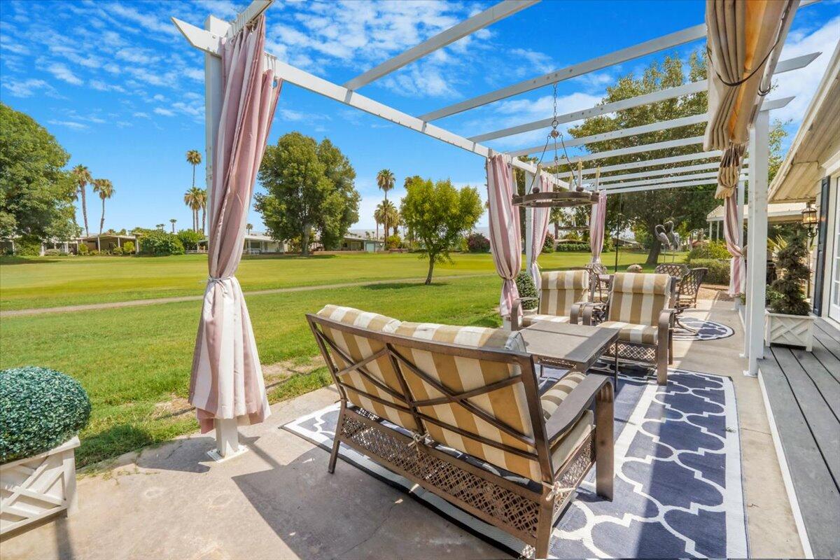 a view of a patio with a table chairs and a backyard