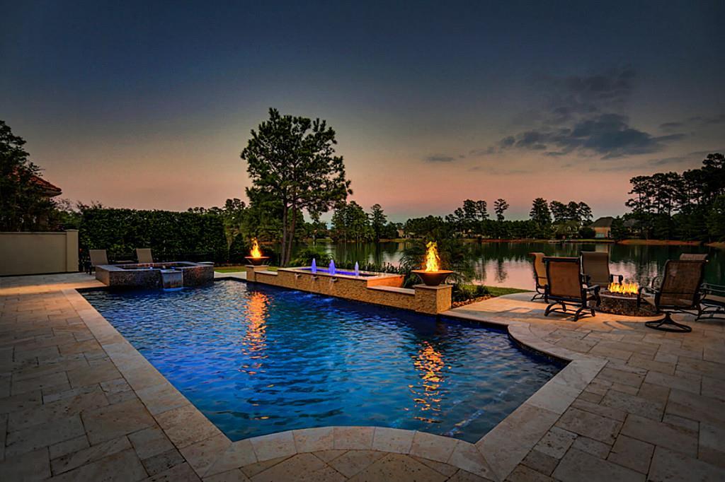 a swimming pool with outdoor seating and barbeque oven