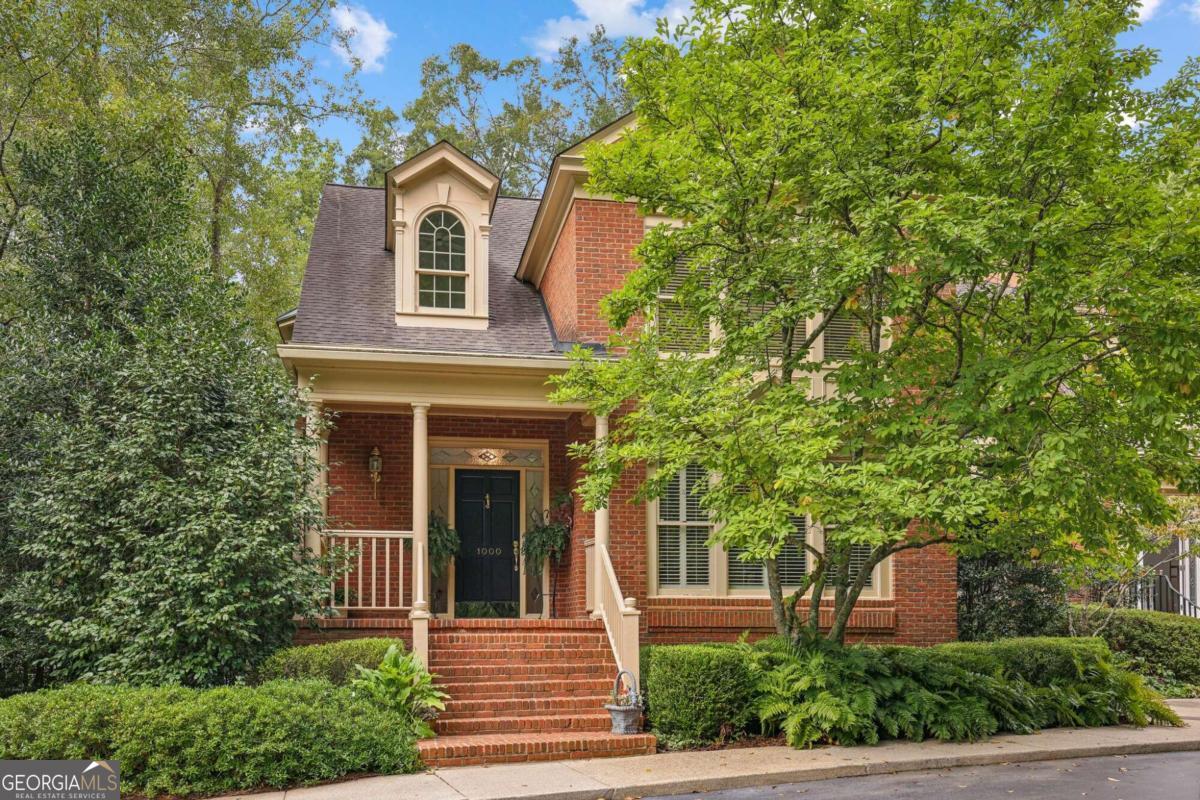 front view of a house with a tree