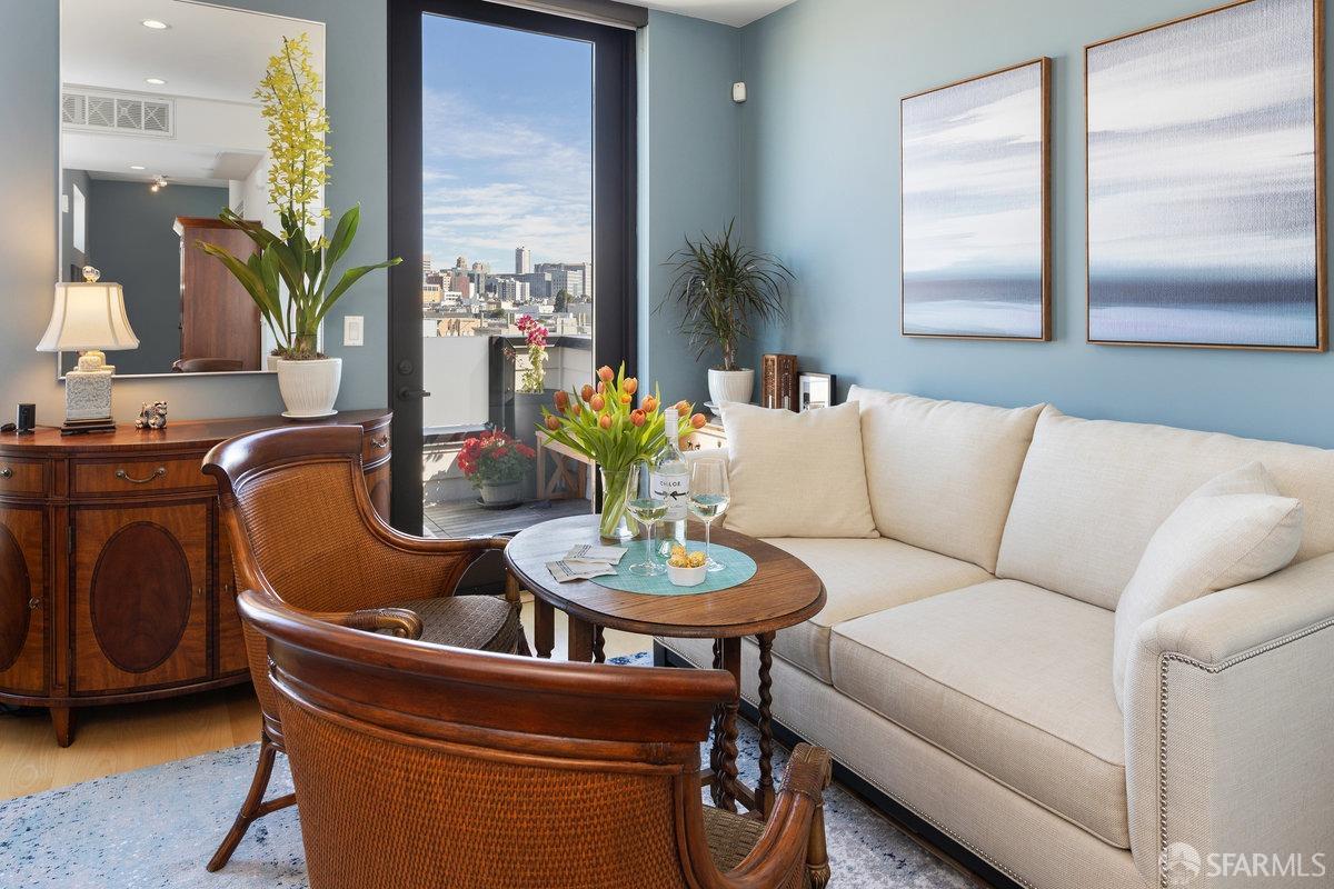 a living room with furniture and a dining table