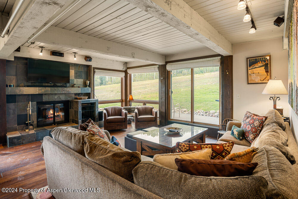 a living room with furniture fireplace and a flat screen tv