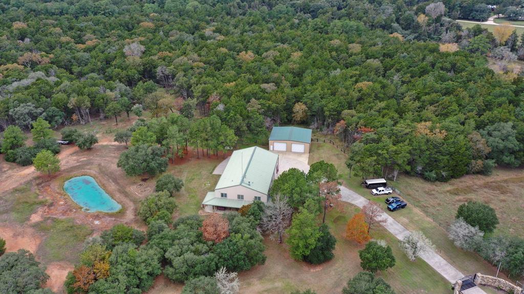 an aerial view of a house with a yard and outdoor seating