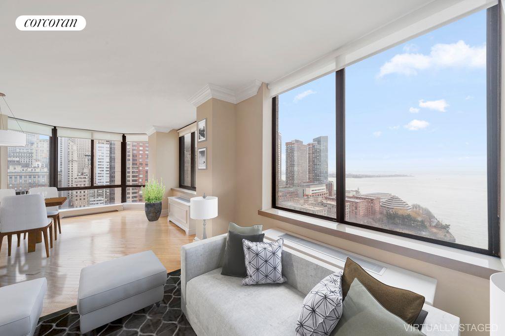 a living room with furniture and large windows