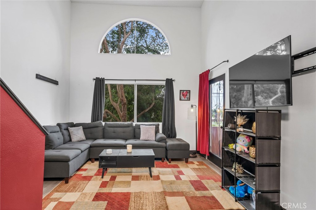 a living room with furniture and a book shelf