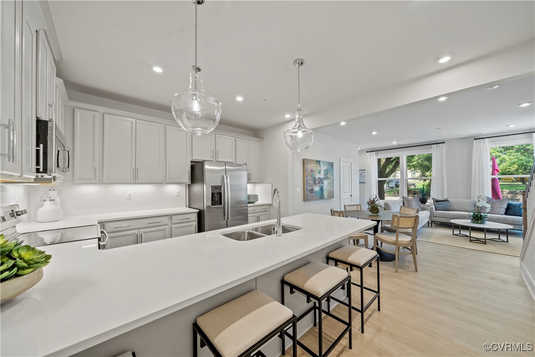 a large kitchen with a table and chairs