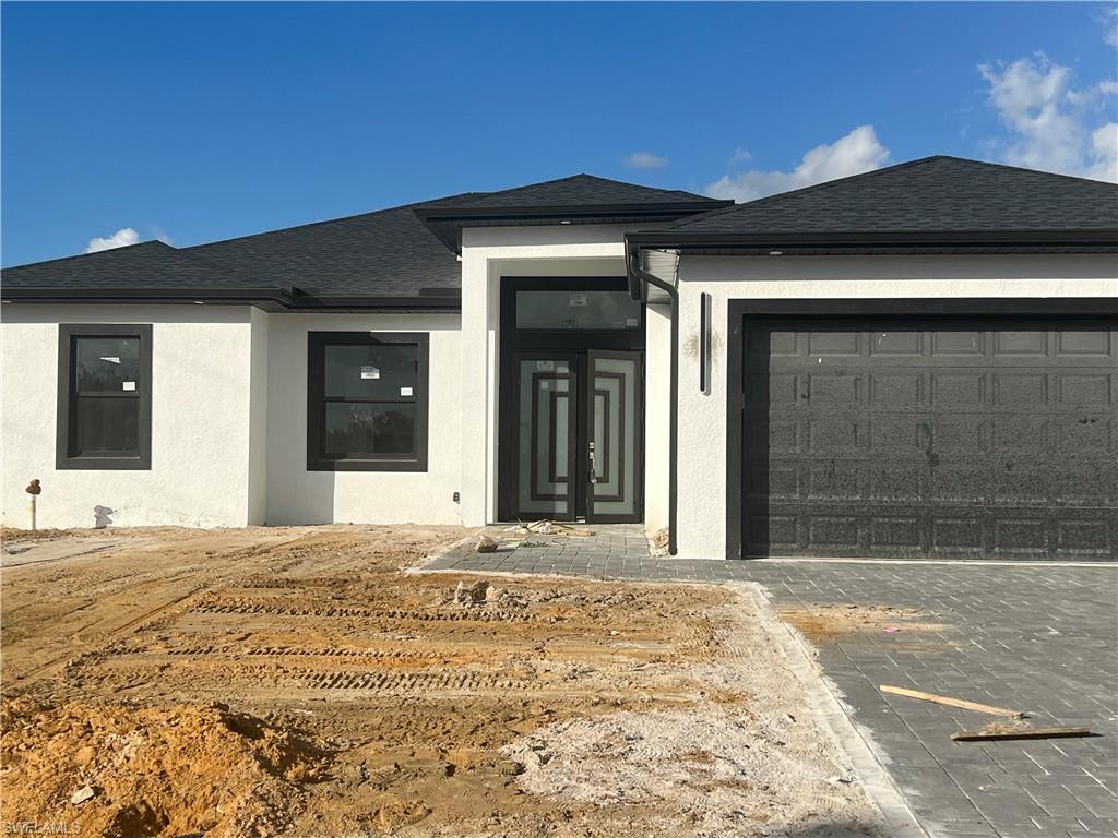 Doorway to property featuring a garage