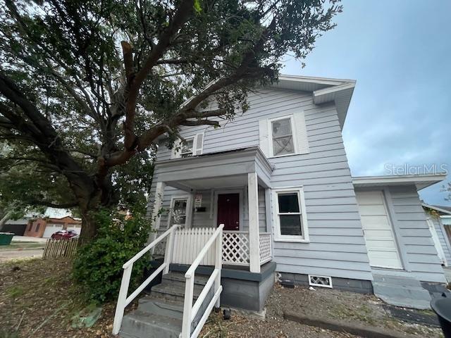 a front view of house with deck and yard