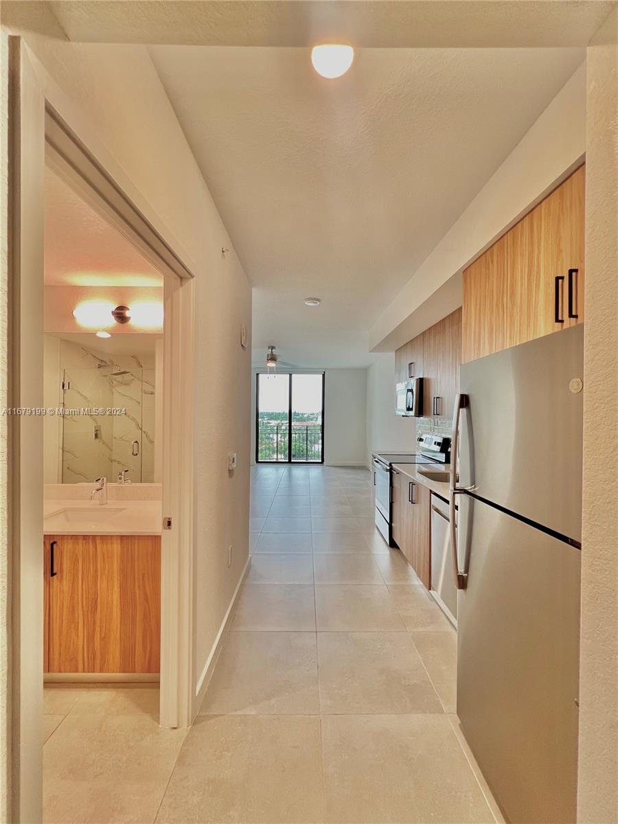 a view of kitchen with furniture and refrigerator