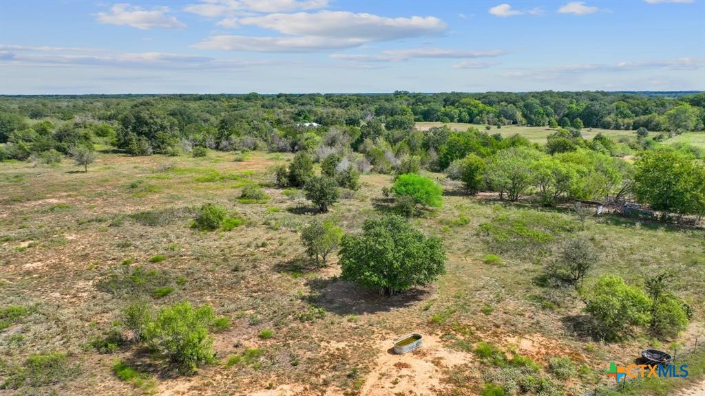 a view of a field with an trees