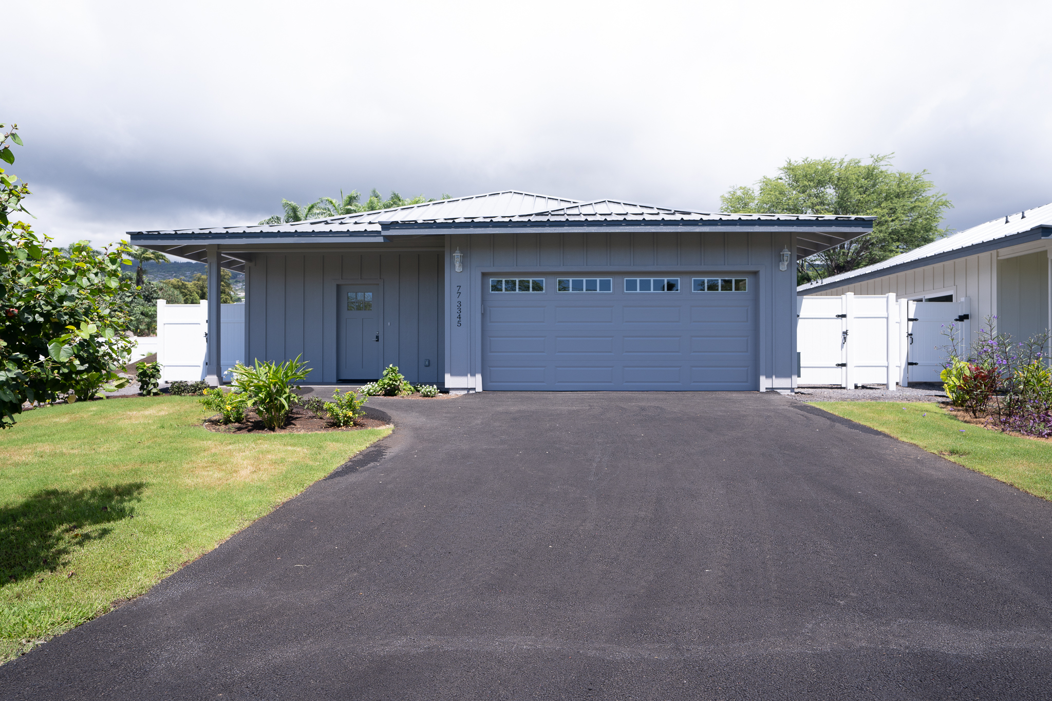 a view of a house with a yard and garage