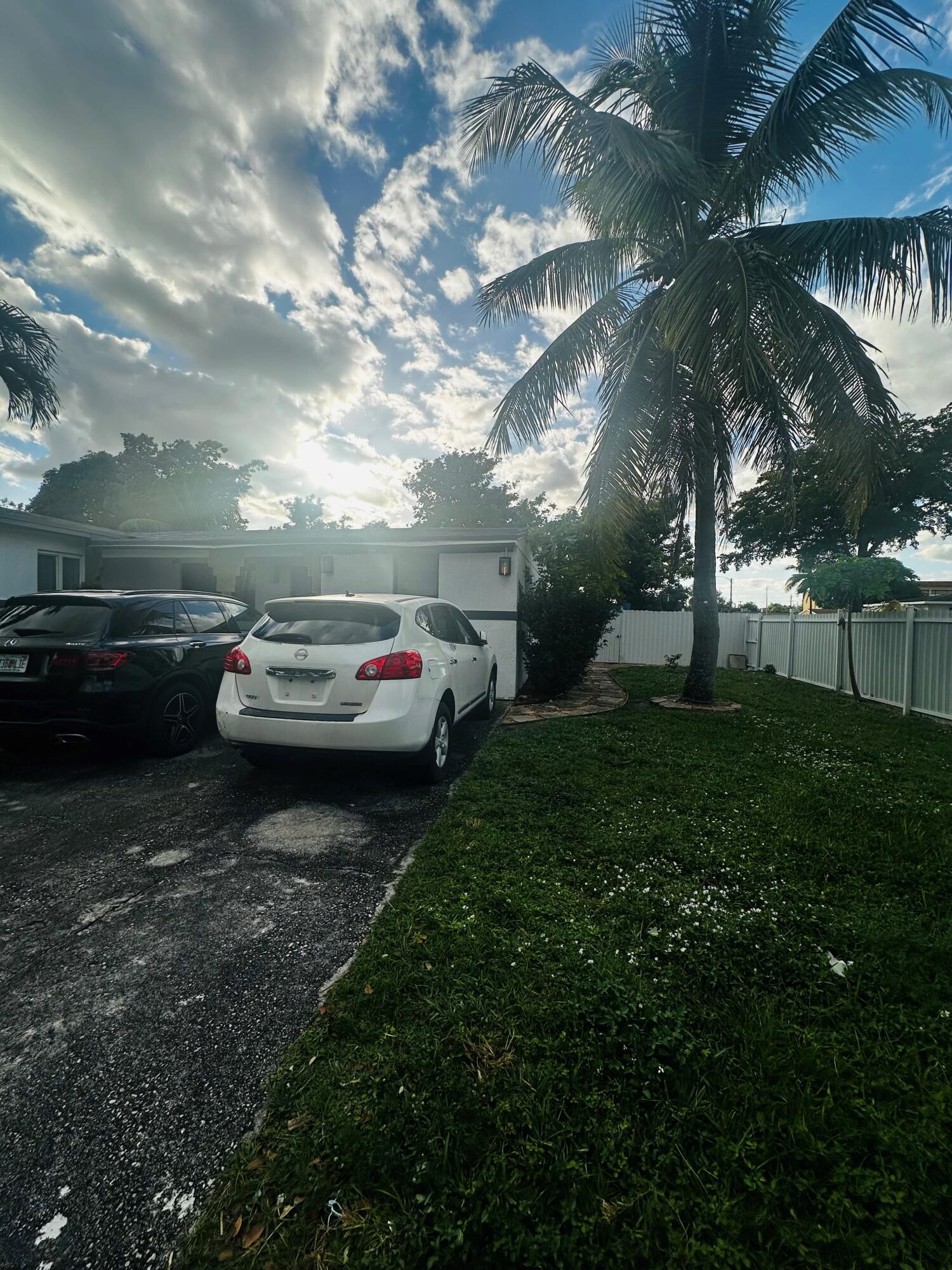 a couple of cars parked in a yard next to a building