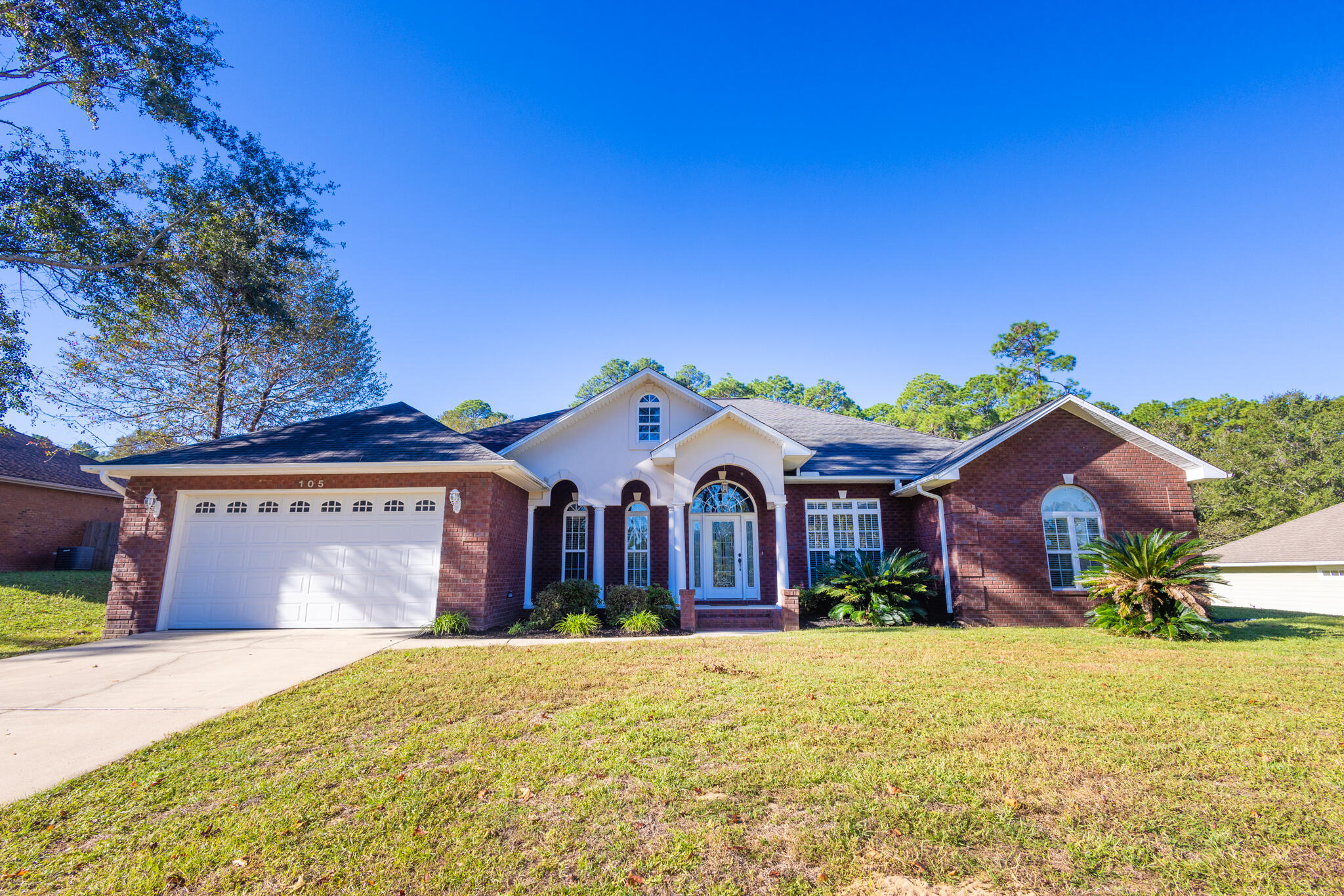 a front view of a house with a yard and garage