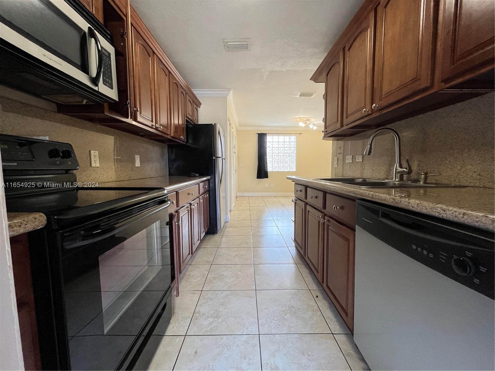 a kitchen with stainless steel appliances granite countertop a stove and a sink