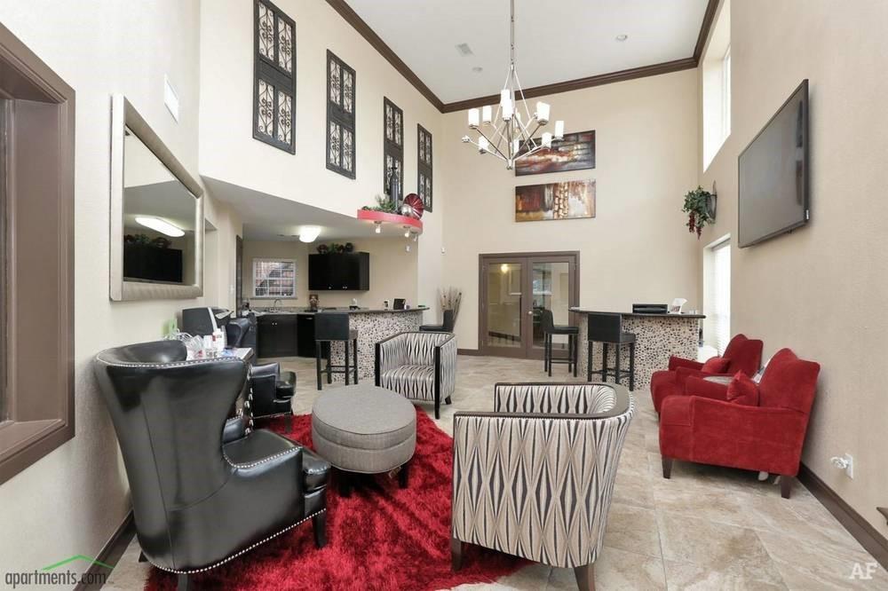 a living room with furniture a flat screen tv and kitchen view