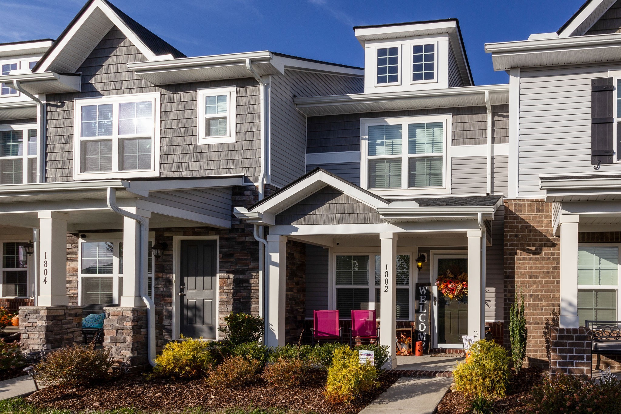 a front view of a residential apartment building with a yard