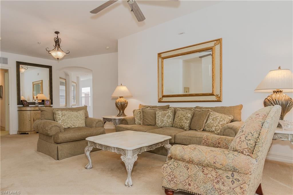 a living room with furniture and a large mirror