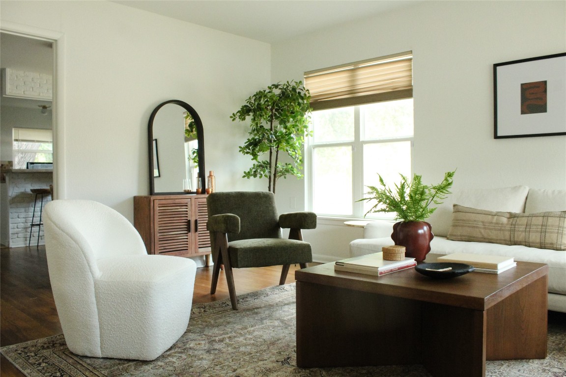 a living room with furniture potted plant and a window