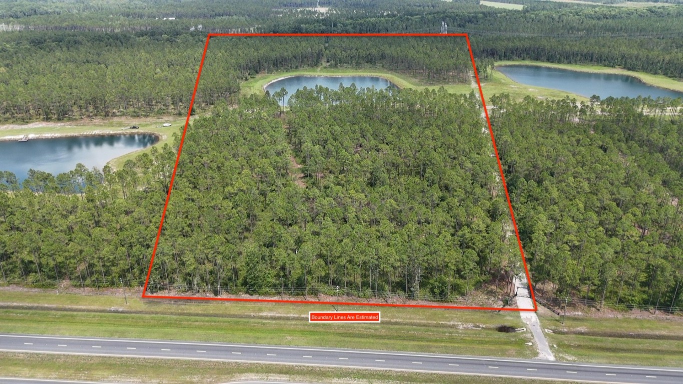 a view of a water pond with green yard