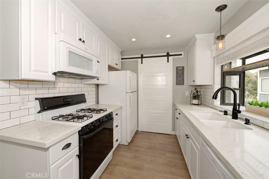 upgraded kitchen with quartz countertops,  tile backsplash, and recessed LED lighting