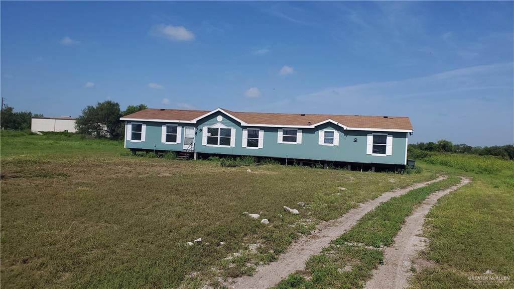 a view of a house with a big yard