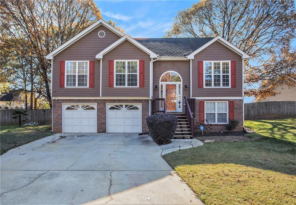 a front view of a house with a yard and garage