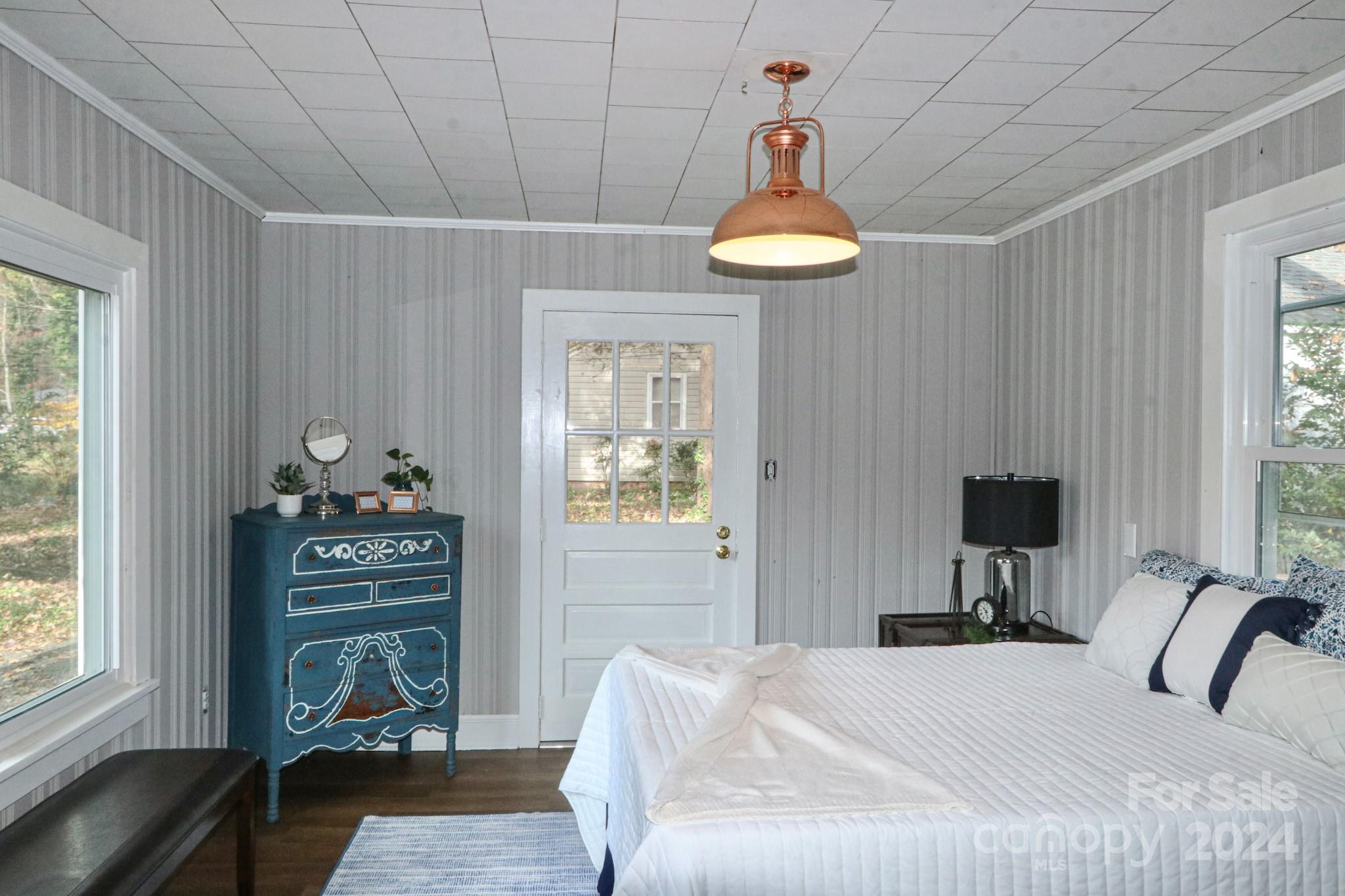 a bedroom with a bed and a chandelier