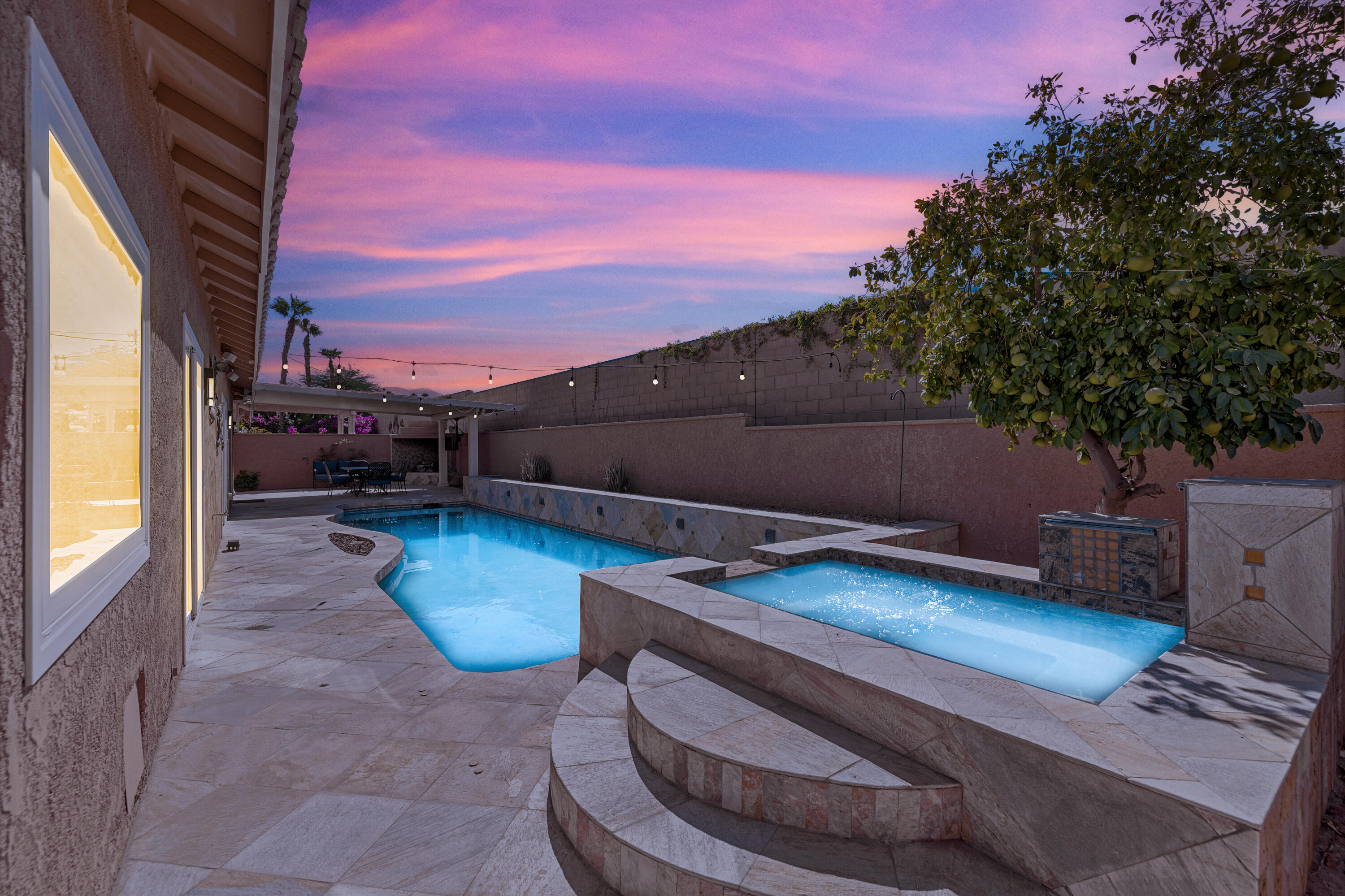 a view of a backyard with furniture and a tub