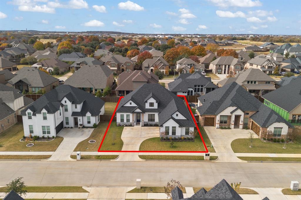 an aerial view of a house with a swimming pool