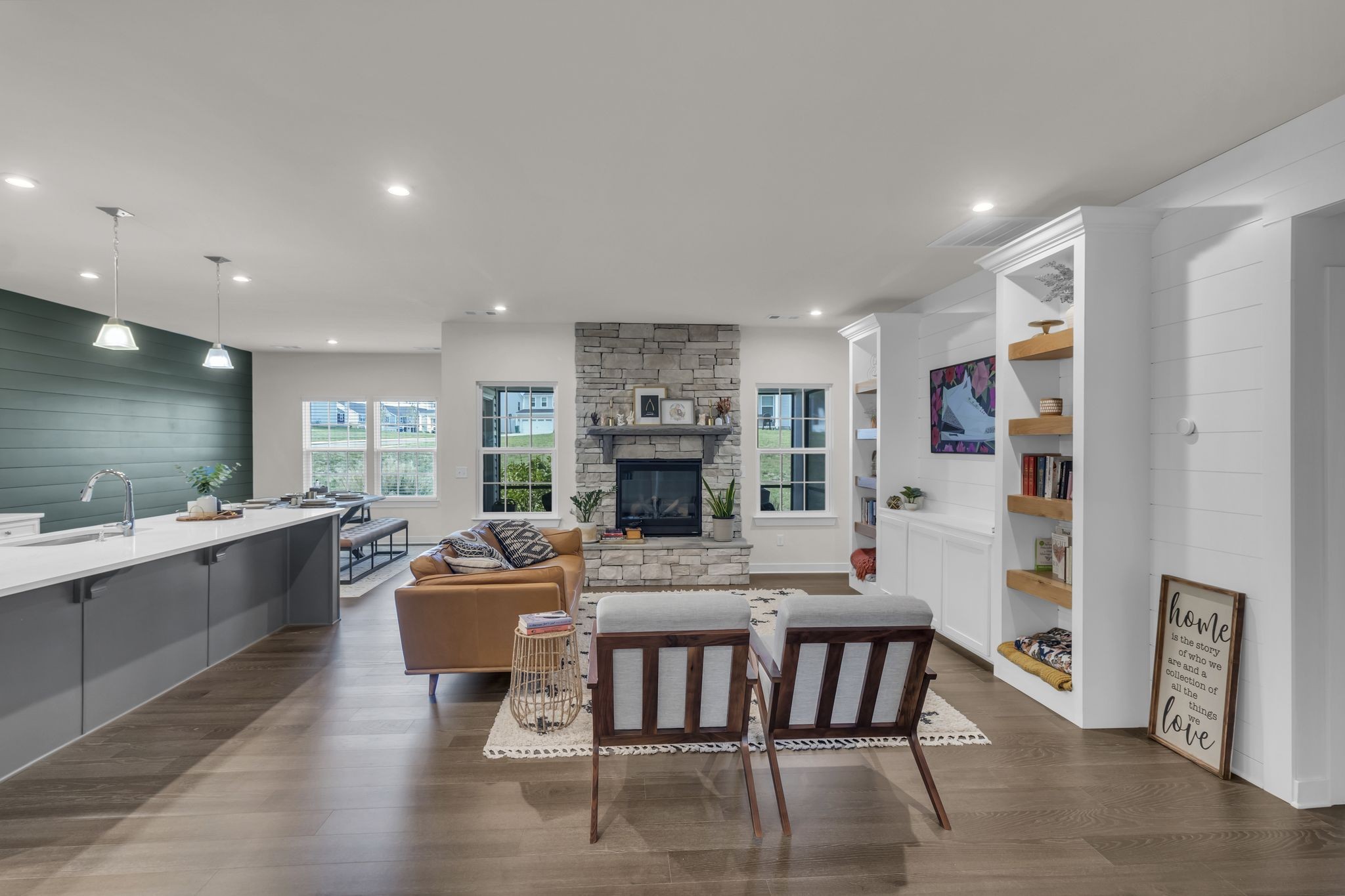 a living room with fireplace furniture and a wooden floor