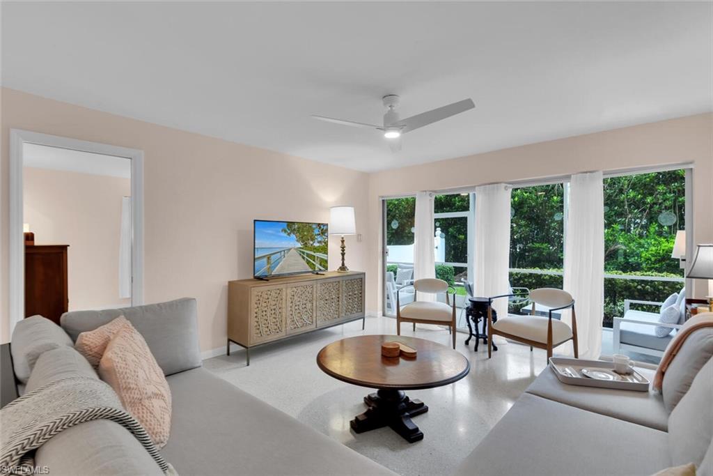 a living room with furniture and a large window