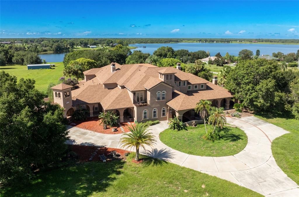 an aerial view of a house with outdoor space lake view