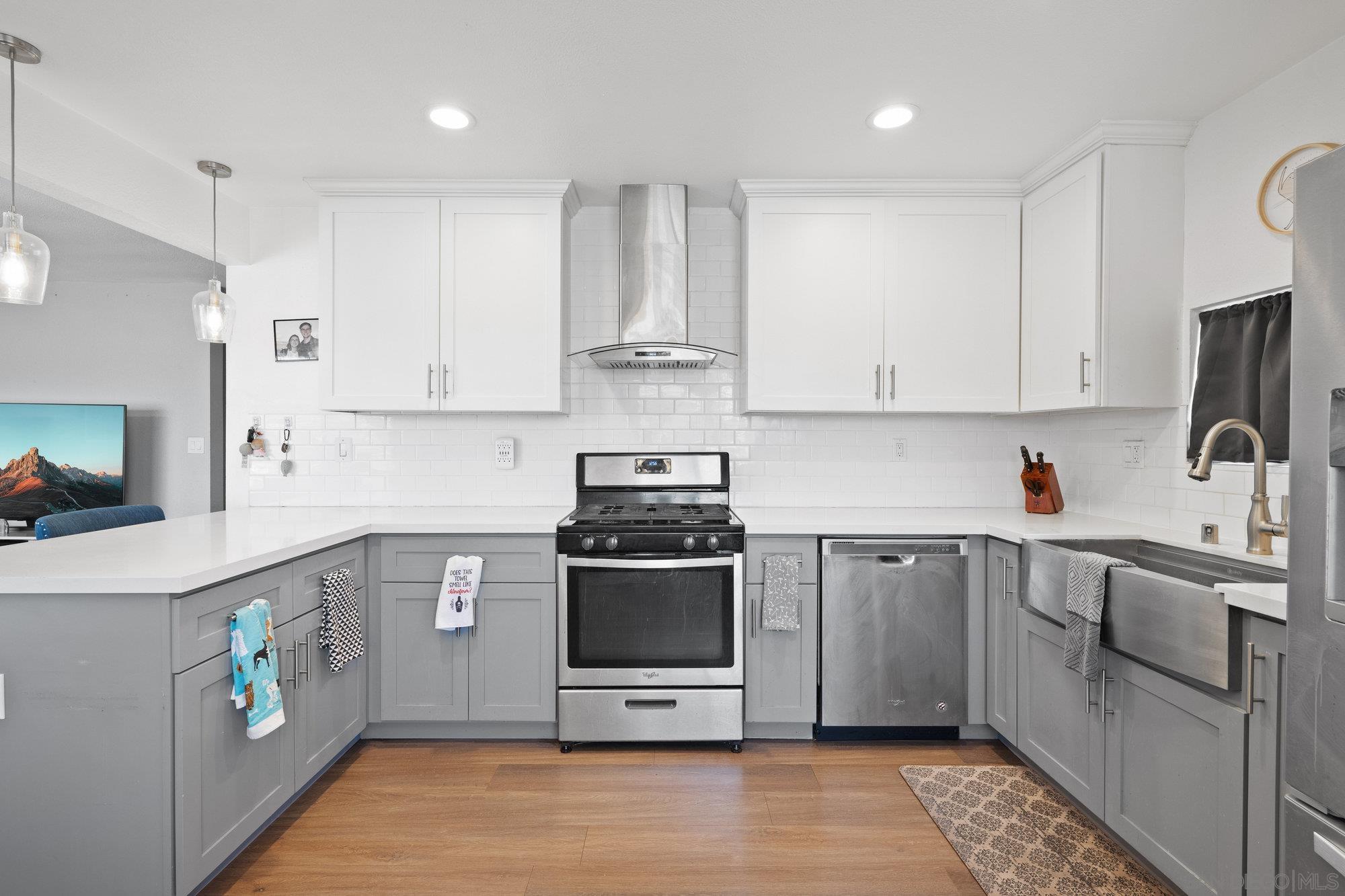 a kitchen with stainless steel appliances granite countertop a stove and a sink