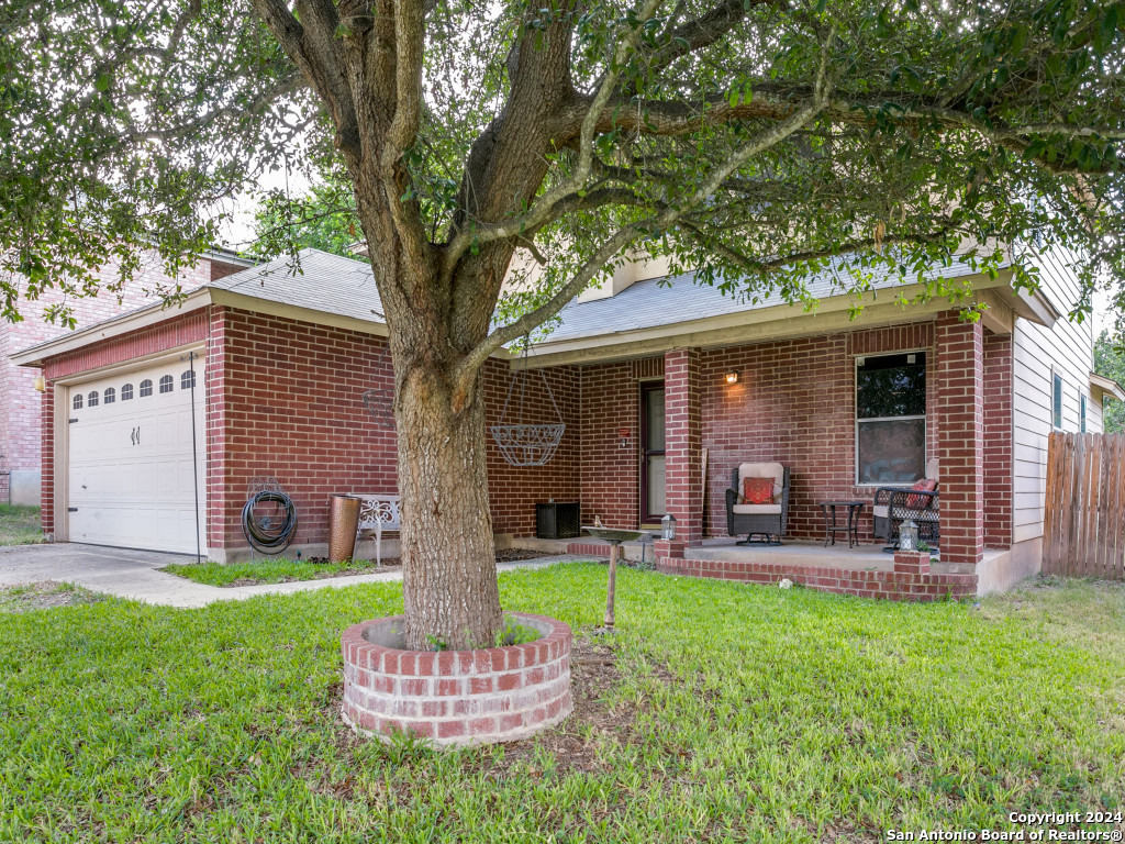 a front view of house with a garden and patio