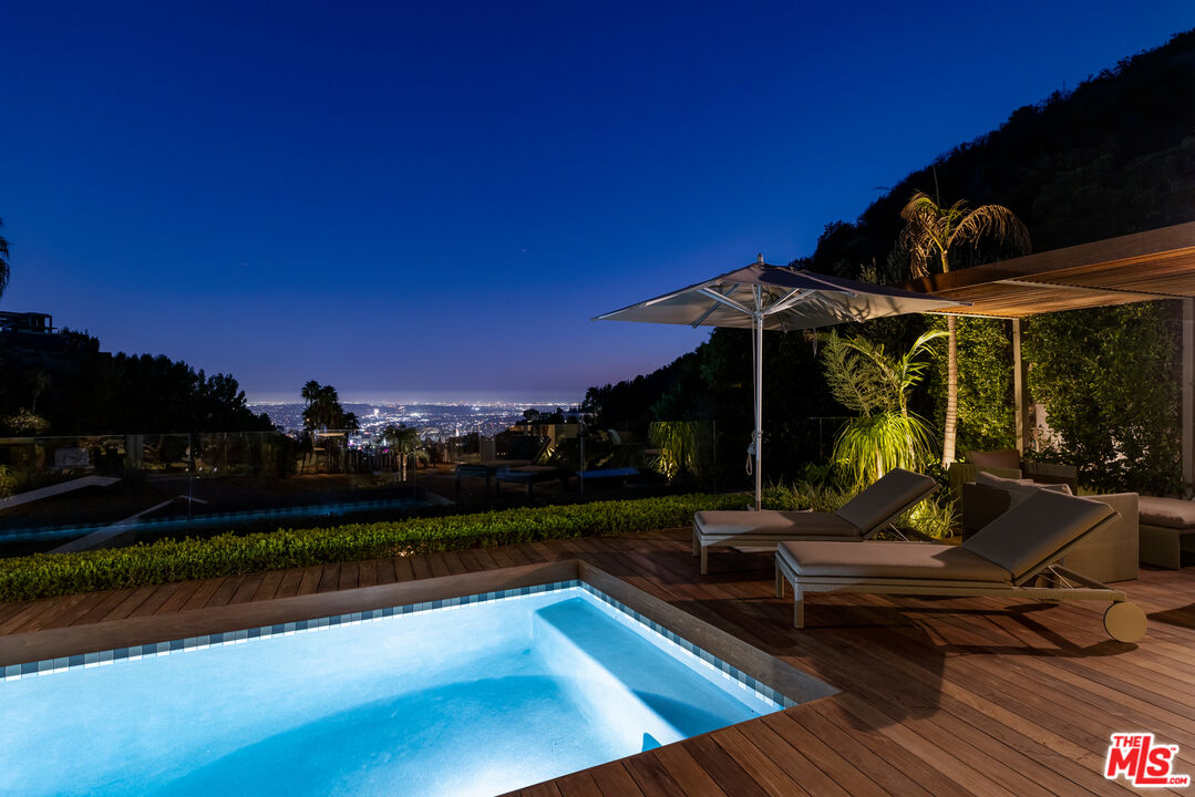 a view of a swimming pool with a lounge chair