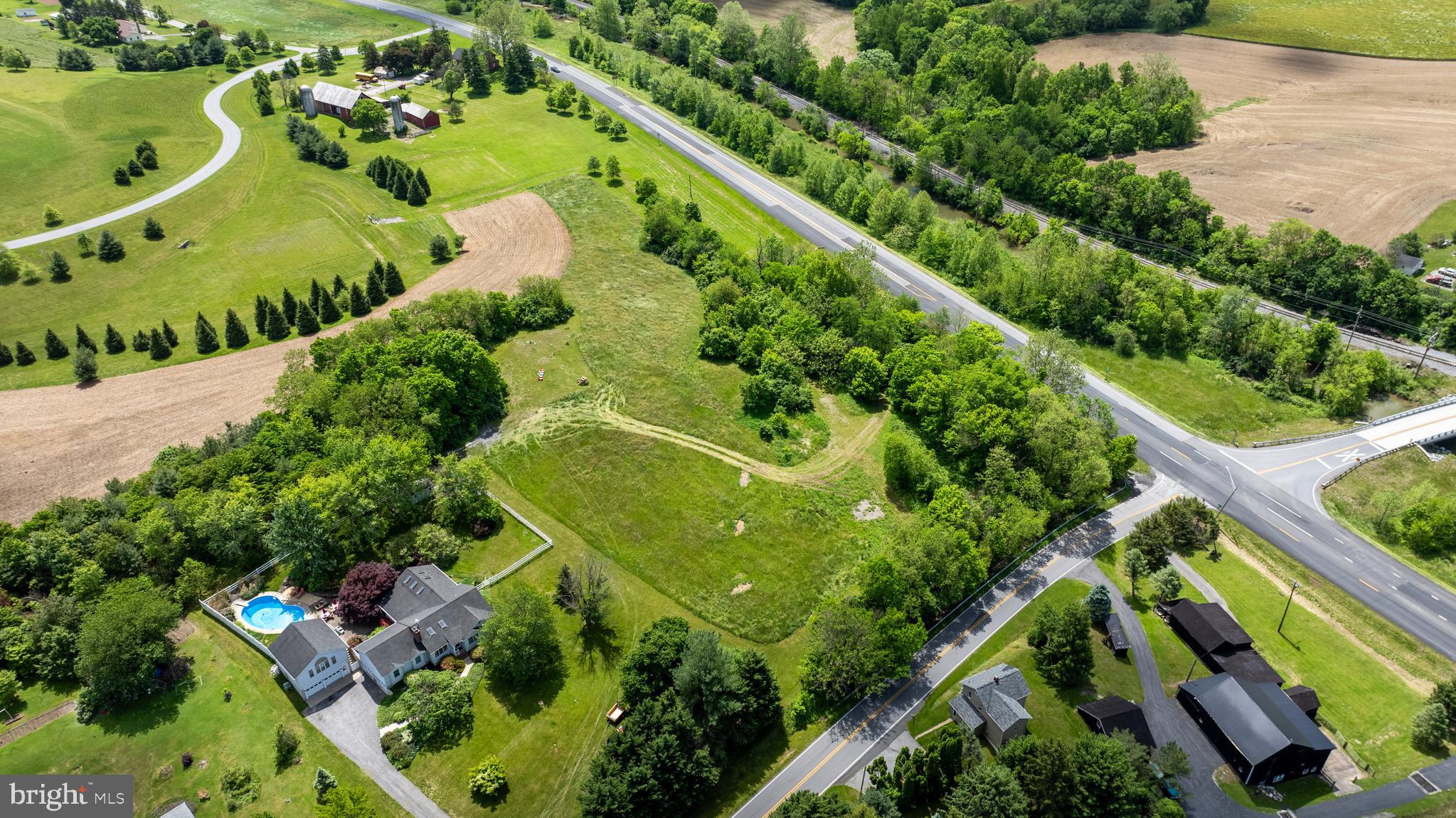 an aerial view of a residential houses with outdoor space and street view