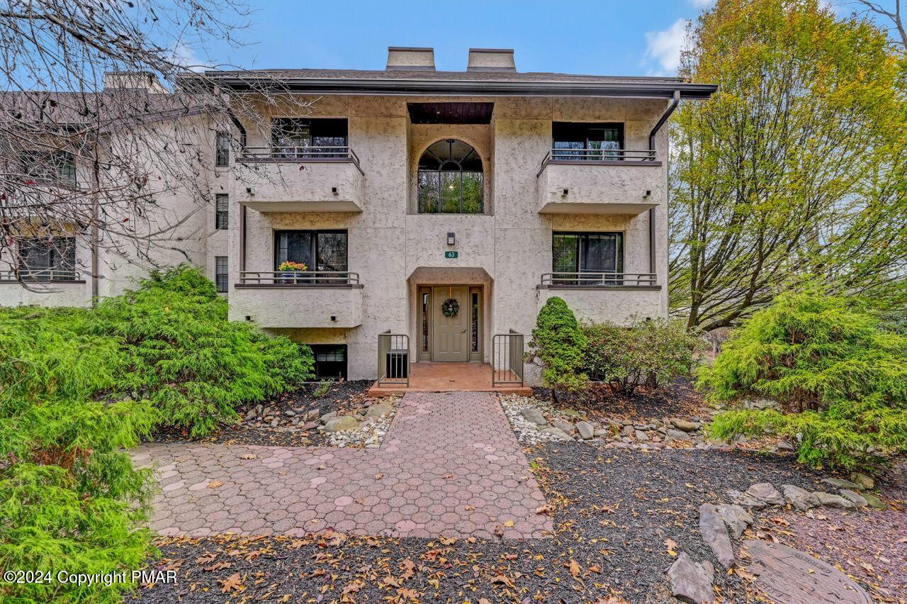 a front view of a house with garden