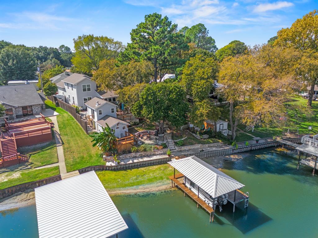 an aerial view of a house with swimming pool and lake view